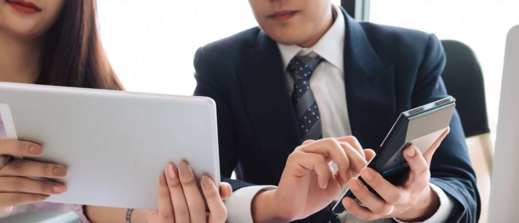 Business professionals reviewing financial data and documents while preparing to register company in Dubai for a new business setup.